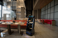 KBS Serviceroboter T5 von schräg vorne in stilvoller Restaurantumgebung. Offene Servierflächen mit Speisen befüllt – perfekt für Gastronomiebetriebe mit innovativen Servicekonzepten.
